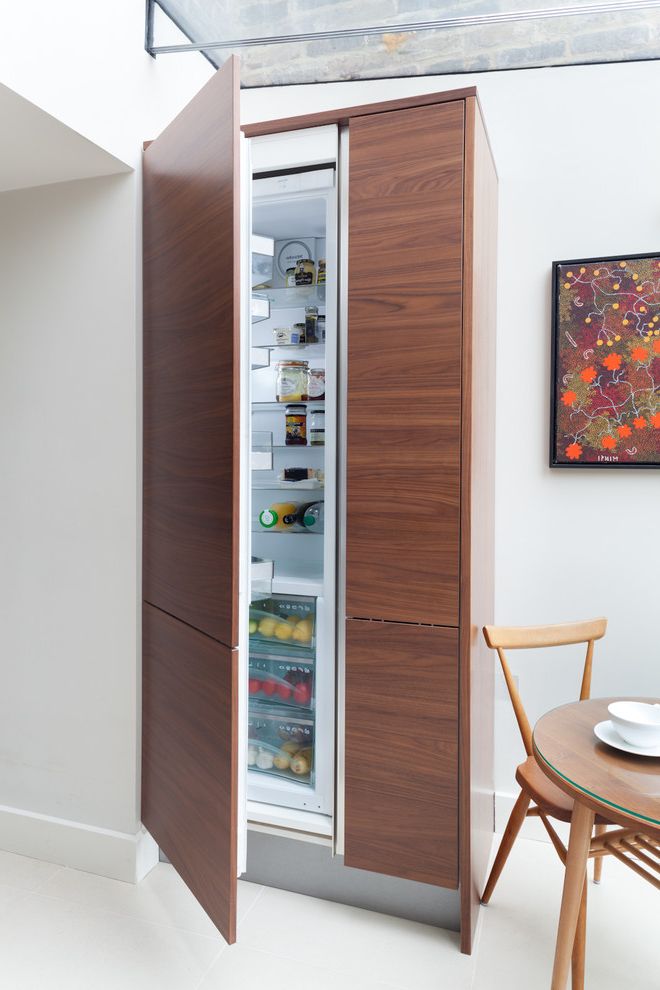 Advanced Distribution Services with Contemporary Kitchen  and Baseboard Flat Panel Cabinets Glass Ceiling Integrated Refrigerator Interior Design Details Walnut White Walls Wood Grain