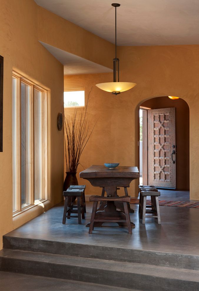 American Concrete Supply with Southwestern Dining Room  and Arched Doorway Carved Door Concrete Floors Exotic Glass Pendant Light Glass Windows Global Ochre Shinto Chair Wood Table