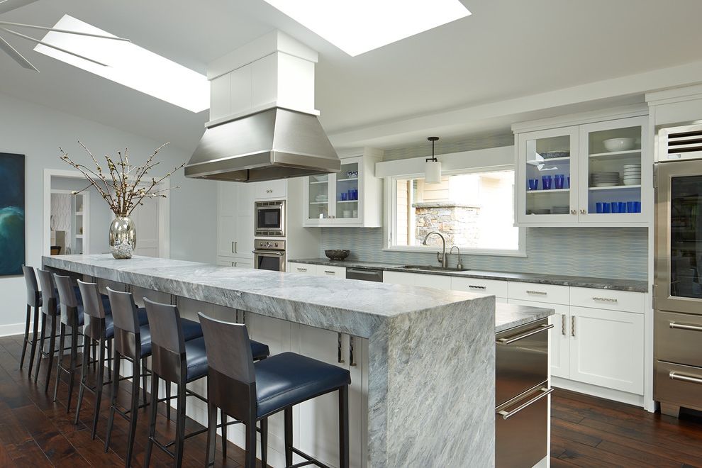 Aztec Appliance   Transitional Kitchen  and Blue and Gray Tiles Cast Stone Cool Colors Custom Hardwood Miele Porcelain Tiles Skylights Slanted Roof Vent Over Island Walnut Floors Waterfall Kitchen Island White Cabinets Window Above Sink