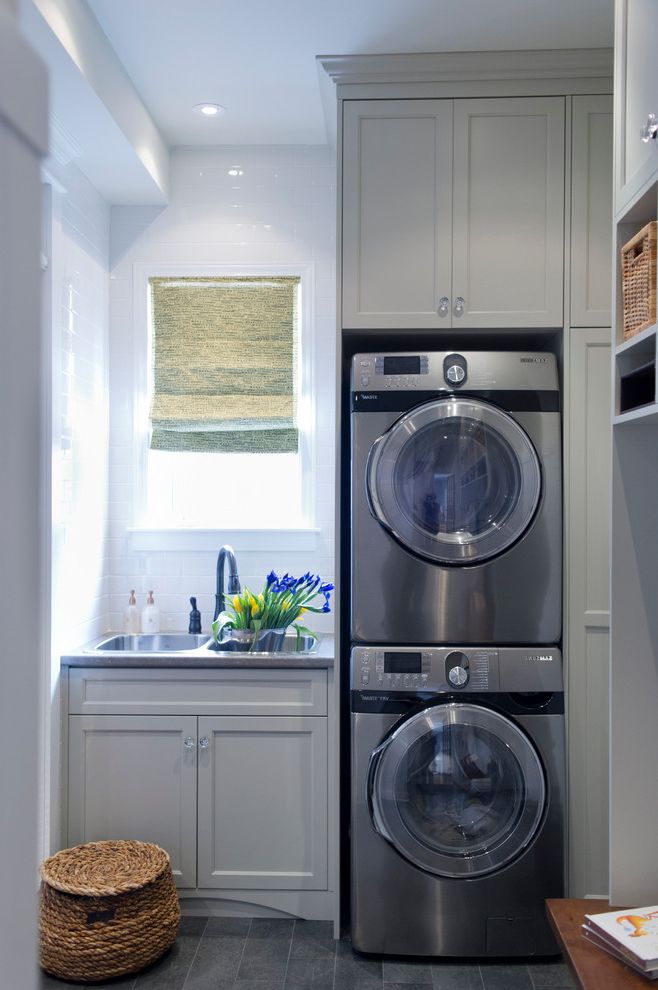 Best Dryer for the Money   Transitional Laundry Room Also Double Sink Gray Cabinets Gray Drawers Laundry Room Sink Roman Shade Shaker Style Stacked Washer and Dryer Stacked Washer Dryer Tile Floor White Subway Tile White Tile Backsplash Wicker Basket