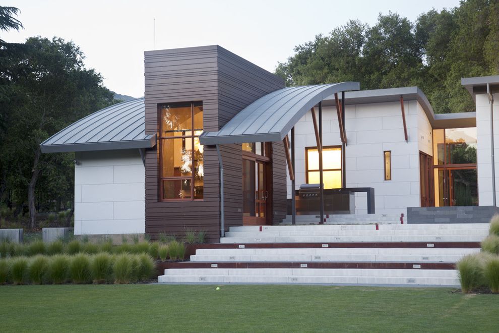 Brown Boys Roofing with Contemporary Exterior Also Arched Roof Brown Cementitious Panels Gray Lawn Metal Roof Modular Steps Tall Grasses Tall Windows