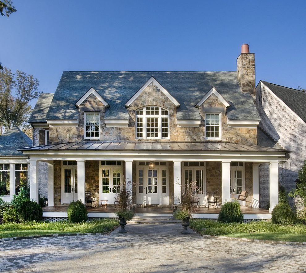 Buying Land to Build a House   Traditional Exterior  and Columns Covered Patio French Doors Outdoor Seating Porch Rocking Chair Shingles Stacked Stone Standing Seam Roof Swing Transom Windows White White Window Trim