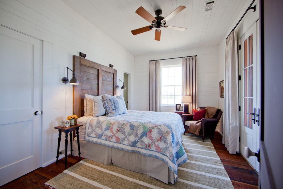 California King Quilts with Farmhouse Bedroom  and Ceiling Fan Chesterfield Chair Contemporary Design French Doors Quilt Updated Farmhouse White Door Knob White Walls Wood Floors Wood Headboard