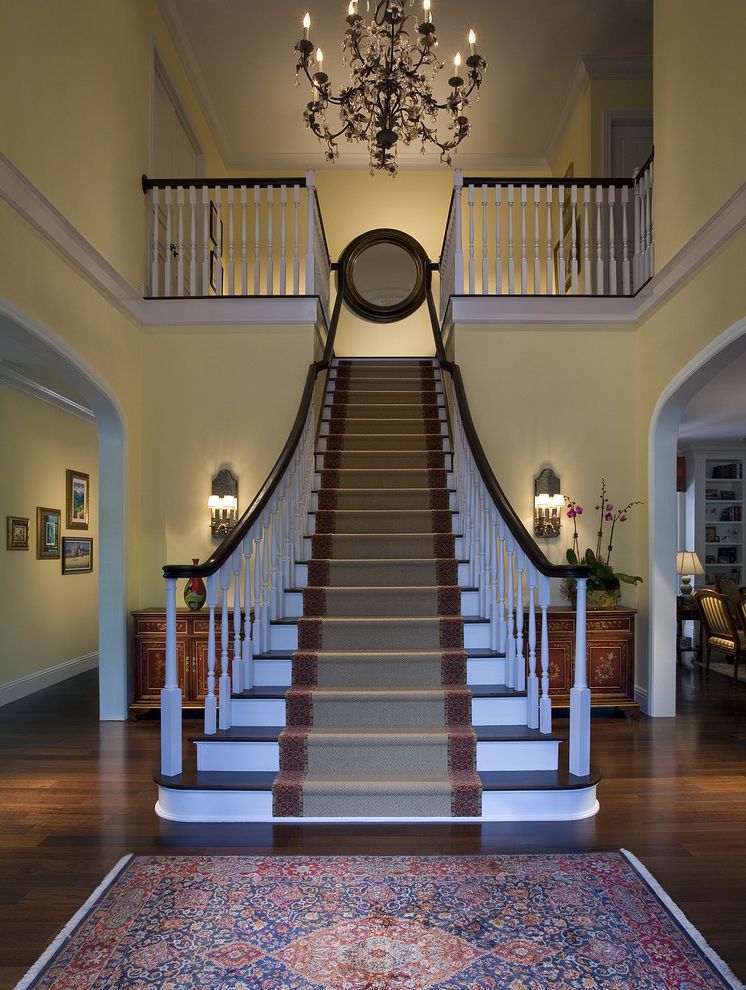 Carpet Cleaning Brooksville Fl   Traditional Staircase Also Black Chandelier Console Crystal Chandelier Foyer Grand Staircase Mirrored Sconce Orchid Oriental Rug Round Mirror Runner Sconce White Spindles Wood Banister Wood Railing
