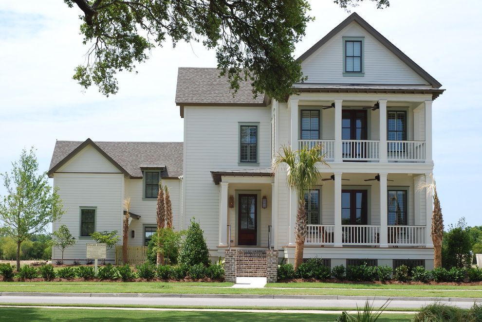 Charleston Homes Omaha with Traditional Exterior Also Balcony Columns Entrance Entry Front Door Grass Handrail Lawn Neutral Colors Outdoor Lighting Path Plantation Porch Turf Walkway White Wood Wood Railing Wood Siding Wood Trim