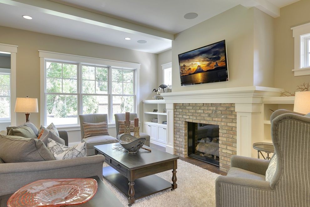 Clayton Homes Lafayette   Traditional Family Room  and Almond Walls Beige Walls Brick Fireplace Built in Bookcase Dark Wood Coffee Table Enameled Trim Exterior Brick Fireplace High Pile Rug Off White Walls Slipper Chairs Tv Above Fireplace