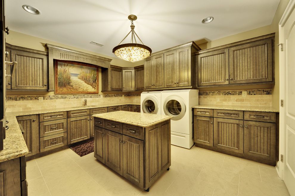 Commercial Grade Washing Machine with Traditional Laundry Room Also Cream Colored Tiles Dryer Island on Wheels Laundry Room Stone Countertop Tiled Backsplash Tiled Floor Washer Washing Machine Wood Cabinets