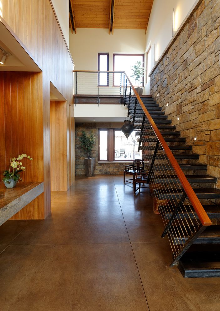 Concrete Staining Oc   Contemporary Staircase  and Black Tread Built Ins Cedar Entry Hall Horizontal Steel Railing Mahogany Handrail Open Riser Stairs Stained Concrete Floor Stone Wall Windows Wood Paneling