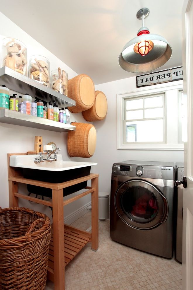 Corner Utility Sink with Eclectic Laundry Room  and Baskets Collection Floating Shelves Pendant Lighting Stainless Steel Appliances Storage Tile Flooring Utility Tub Wall Decor Wall Sign Wicker Hamper