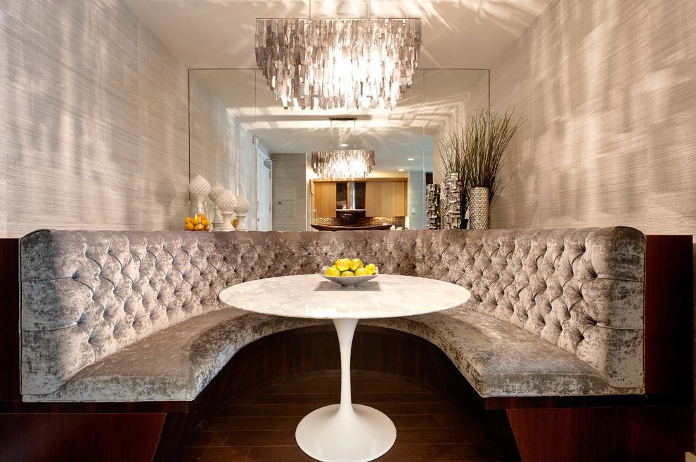 Distinctive Fabrics   Contemporary Dining Room  and Banquette Seating Chandelier Crushed Velvet Crushed Velvet Sofa Curved Banquette Dark Stained Wood Formal Gray Luxury Pedestal Table Tufted Upholstery Wall Mirror Wallpaper Wood Floor