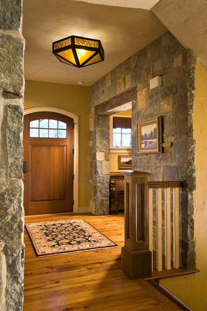 Emtek Keyless Entry with Traditional Entry  and Banister Baseboard Ceiling Lighting Craftsman Foyer Front Door Handrail Rock Wall Rustic Sconce Stone Wall White Wood Wood Door Wood Flooring Wood Railing Wood Trim