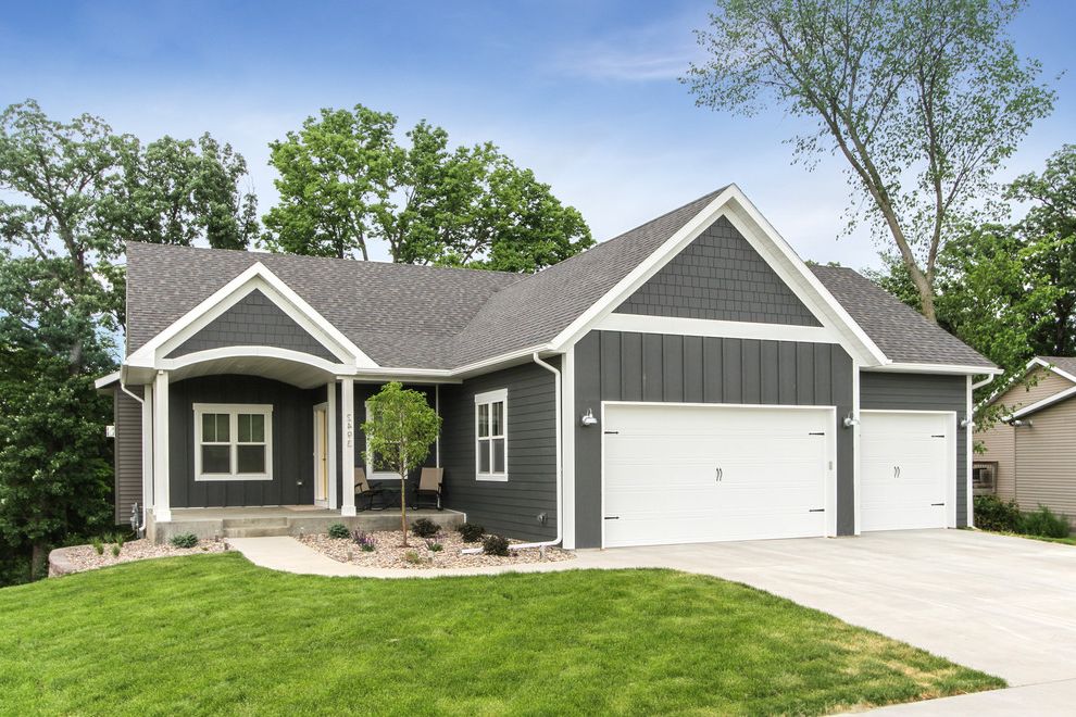 Grey House White Shutters with Traditional Exterior  and Concrete Driveway Concrete Sidewalk Custom Made Grass Gray Exterior Gray House Gray Siding Lawn White Beam White Garage White Garage Door White Post White Window Trim