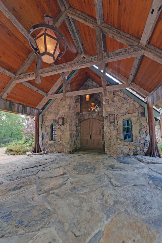 Hand and Stone Port Washington   Rustic Entry  and Arched Window Carport Chandelier Double Front Door Porte Cochere Rustic Wood Beams Stone Driveway Stone Exterior Stone Siding Wood Beam Wood Ceiling Beams Wood Front Door Wood Post Wood Roof Overhang