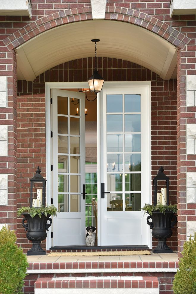 Homemakers Des Moines with Traditional Entry  and Arched Doorway Brick Wall French Doors Glass Front Doors Lantern Pendant Light