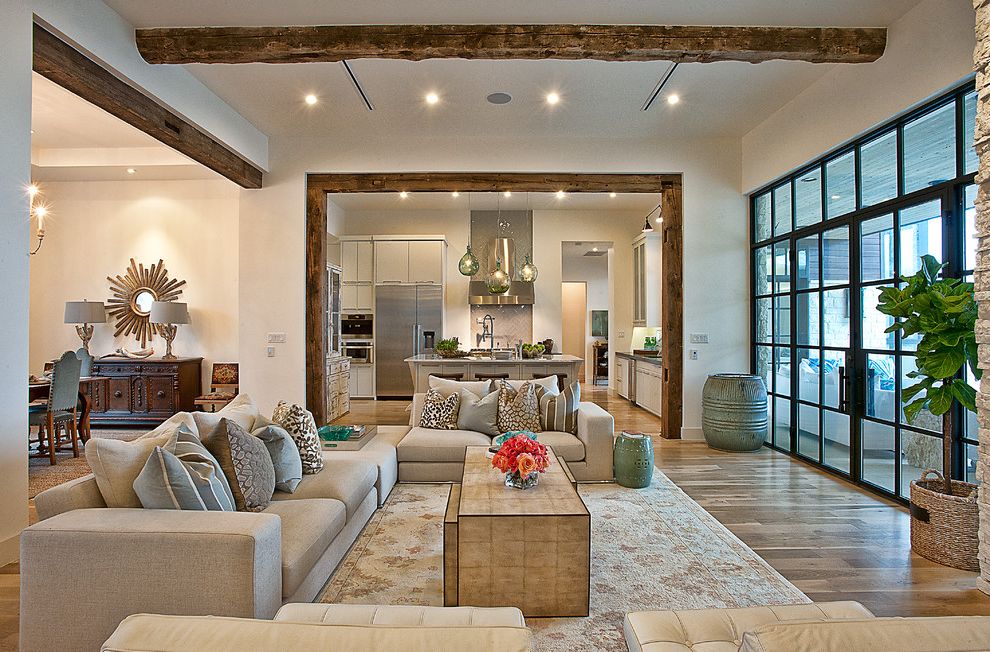 How Much Does a Architect Make with Transitional Living Room and Area Rug Beige Firepace Patio Seating Area Sectional Slant Ceilings Stone Wall Tall Windows White Leather Tufted Upholstery Wood Beams Wood Floors