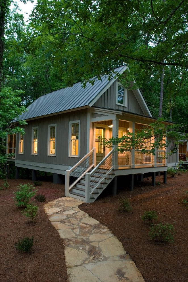 How to Figure Out Square Footage with Rustic Exterior Also Board and Batten Siding Cabin Covered Porch Craftsman Gable Roof Gray Siding Lean to Roof Metal Roof Mulch Paved Pathway Porch Steps Refined Rustic Stone Path Vertical Seam White Railing