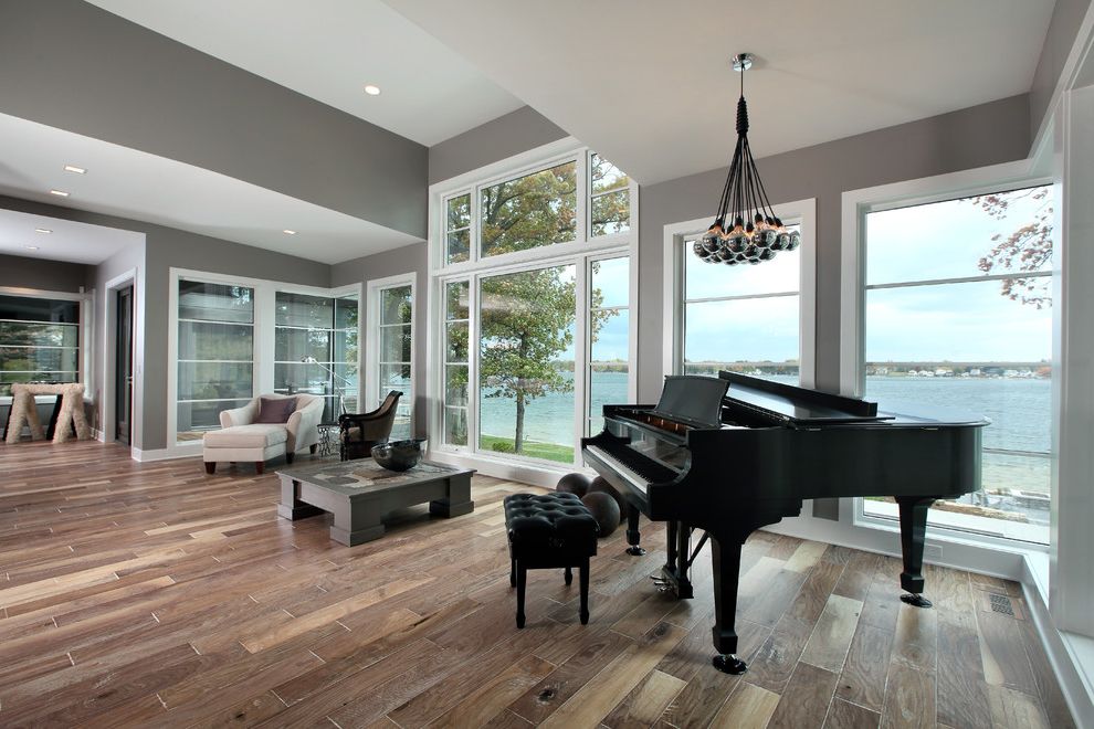 Indoor Water Park Grand Rapids Mi with Contemporary Living Room  and Black Grand Piano Cluster Pendant Light Gray Coffee Table Gray Walls Large Windows Recessed Lighting Upholstered Piano Bench View Waterfront White Armchair Wood Grain Floor