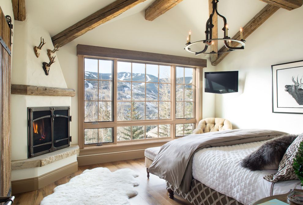 Jen Weld Windows with Rustic Bedroom  and Antler Area Rug Chandeliers Mantel Mountain Home Reclaimed Wood Frame Ski House Timber Vail Wood Beams