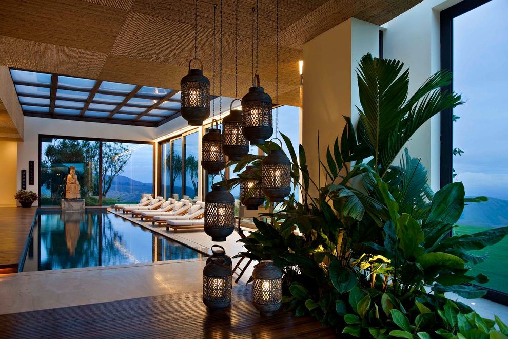 Large Outdoor Hanging Lantern with Tropical Pool Also Accent Ceiling Tiles Asian Sculpture Chaise Lounge Houseplants Indoor Pool Lanterns Natural Straw Outdoor Cushions Patio Furniture Skylights