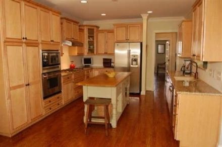 Midsouth Appliances with Traditional Kitchen and Brass Appliances Oak Bench Oak Cabinets Stainless Steel Appliances Tan Walls Traditional Kitchen Wooden Floors