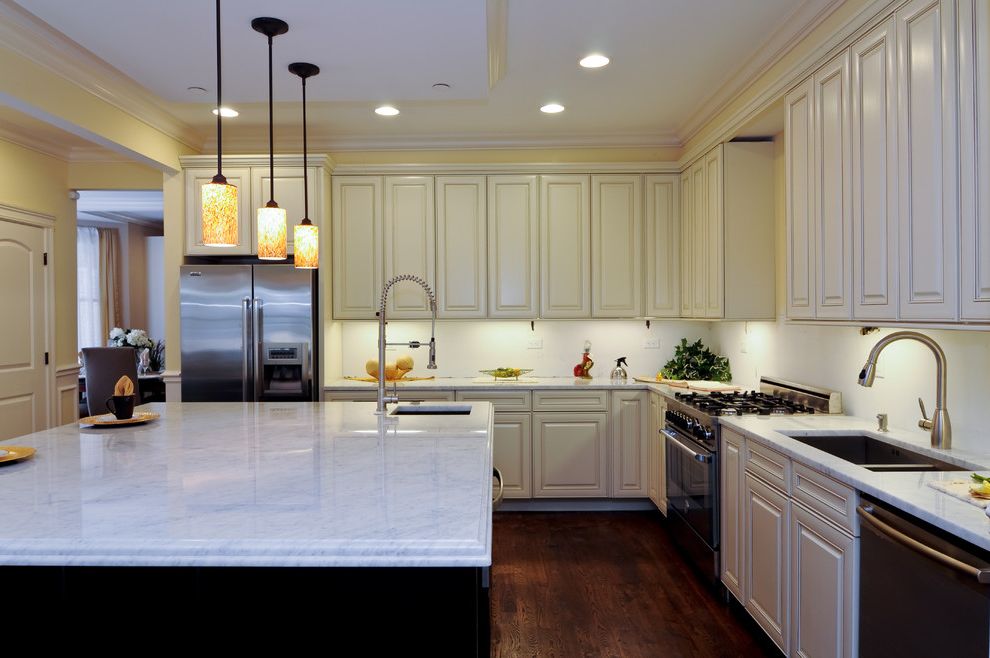Mission Style Pendant Lighting with Traditional Kitchen  and Dark Wood Floor Faucet Kitchen Island Kitchen Island with Sink Large Kitchen Island Pendant Light Stone Countertop White Cabinets Wood Floor