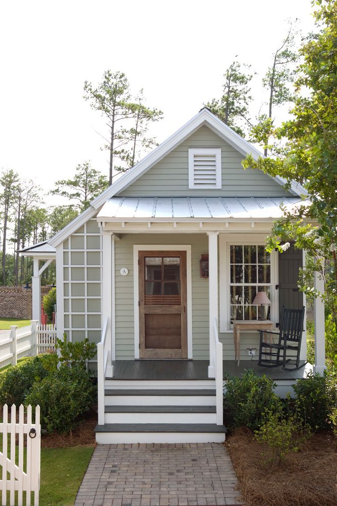 Mobile Home Porch Kits with Farmhouse Exterior and Cabin Cottage Covered Entry Exposed Rafters Front Porch Gable Roof Guest House Lap Siding Louvered Vent Metal Roof Pavers Picket Fence Plants Rocking Chair Shutters Steps Window Wood Lattice