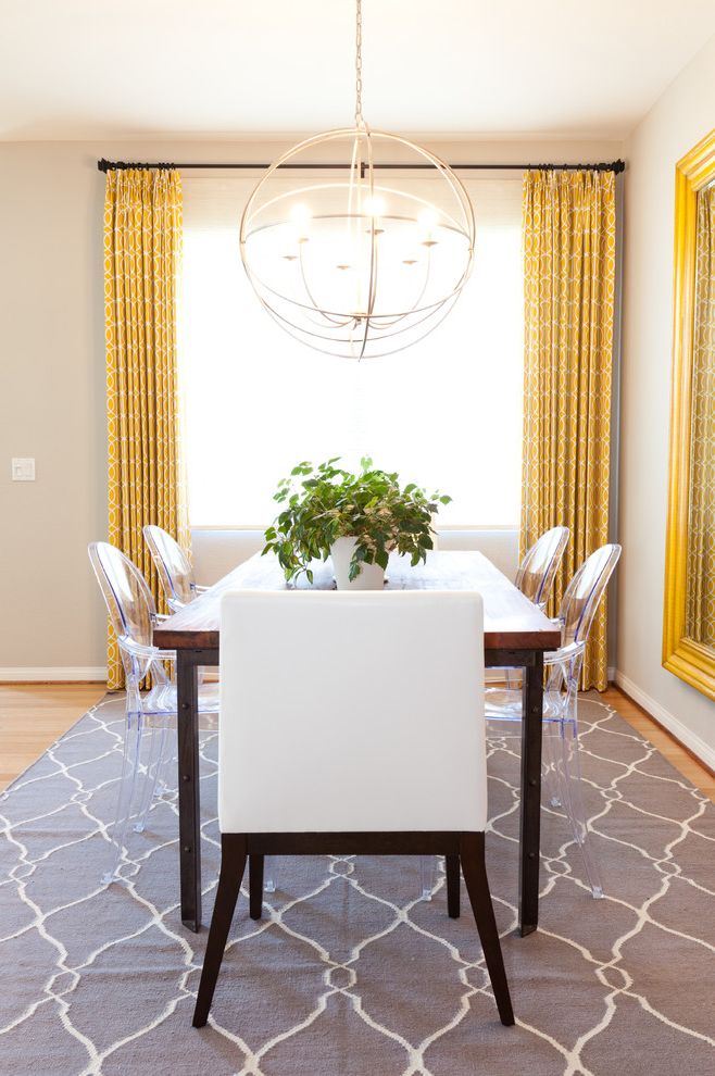Monogram Area Rug with Eclectic Dining Room  and Acrylic Chair Ghost Chairs Gray Area Rug Host Chair Lucite Orb Chandelier Wood Dining Table Yellow Drapes