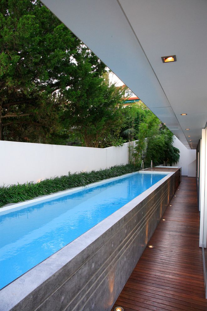 Newark Swimming Pool with Modern Pool  and Above Ground Pool Bamboo Border Plantings Ceiling Lighting Concrete Deck Floor Lighting Garden Wall Geometric Geometry Lap Pool Linear Outdoor Lighting Overhang Recessed Lighting Up Lighting