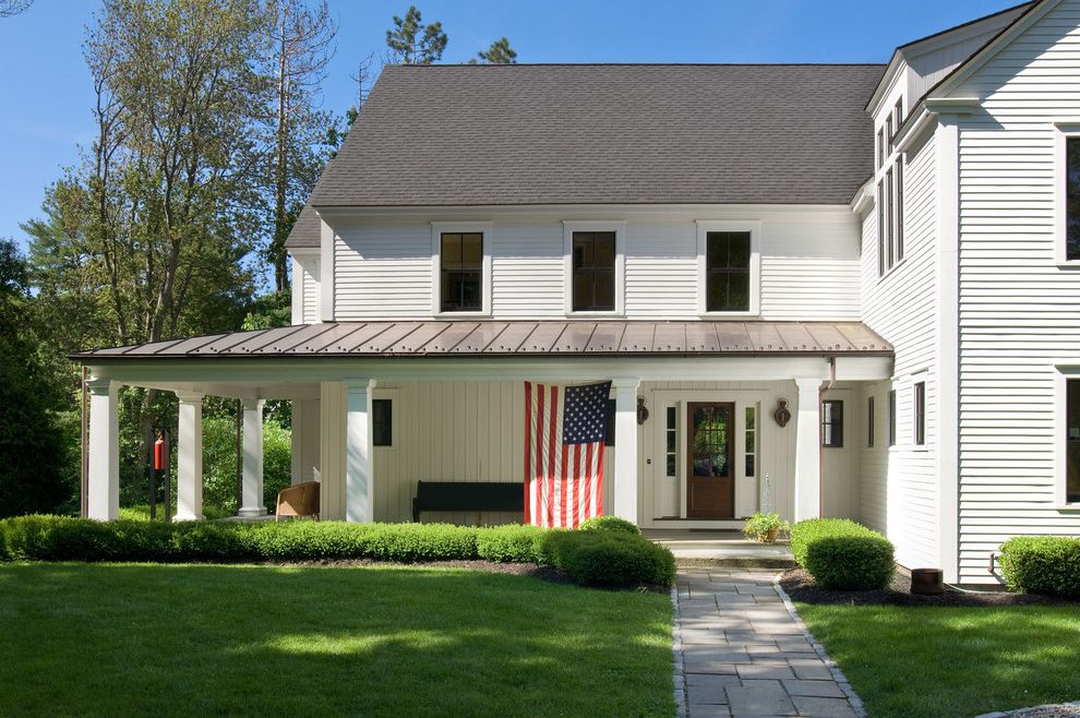 Proper Way to Hang the American Flag   Traditional Exterior Also American Flag Lawn Panel Siding Small Bushes White Exterior White Pilars Wrap Around Porch