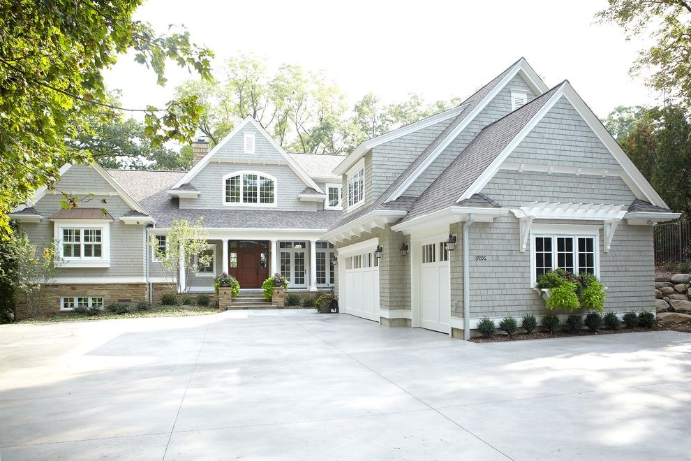 Roof Shingle Colors   Traditional Exterior  and Arched Window Concrete Driveway Gray Shingle Exterior Gray Shingle Siding Stone Exterior Stone Siding Three Car Garage White Column White Garage Door White Pillar White Trim Wood Front Door