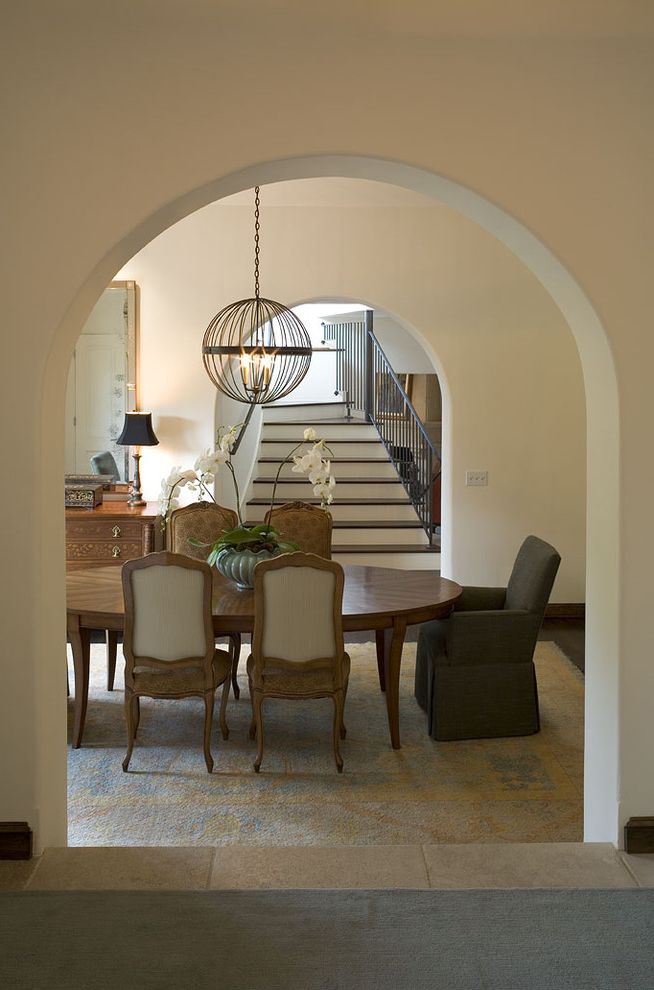 Sherwin Williams Fairfield   Traditional Dining Room Also Arched Doorway Area Rug Dining Area Louis Chairs Neutrals Orb Oval Table Pendant Light Staircase Stone Tile Floor Upholstered Chair