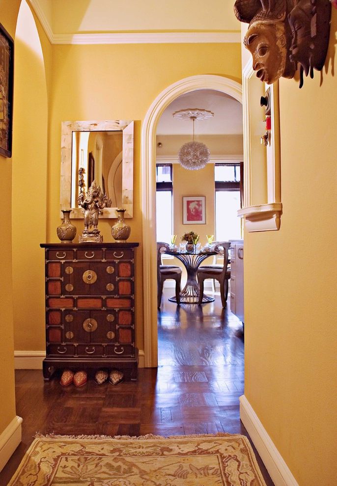 Sherwin Williams Spokane   Eclectic Entry Also Arch Baseboard Ceiling Lighting Console Table Crown Molding Entry Table Foyer Hallway Parquet Flooring Pendant Lighting Runner Rug Vase Wall Decor Wall Mirror Wood Flooring Yellow Wall