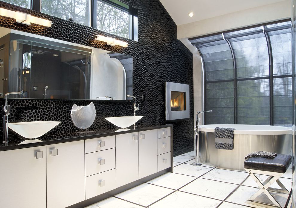 Simons Hardware with Modern Bathroom  and Black Black Counters Black Leather Stool Black Sheer Shade Clerestory Windows Fireplace Mirror Stainless Steel Tub Surround Stone Wall Tile Floor Vaulted Ceiling Vessel Sinks Wall Sconce White