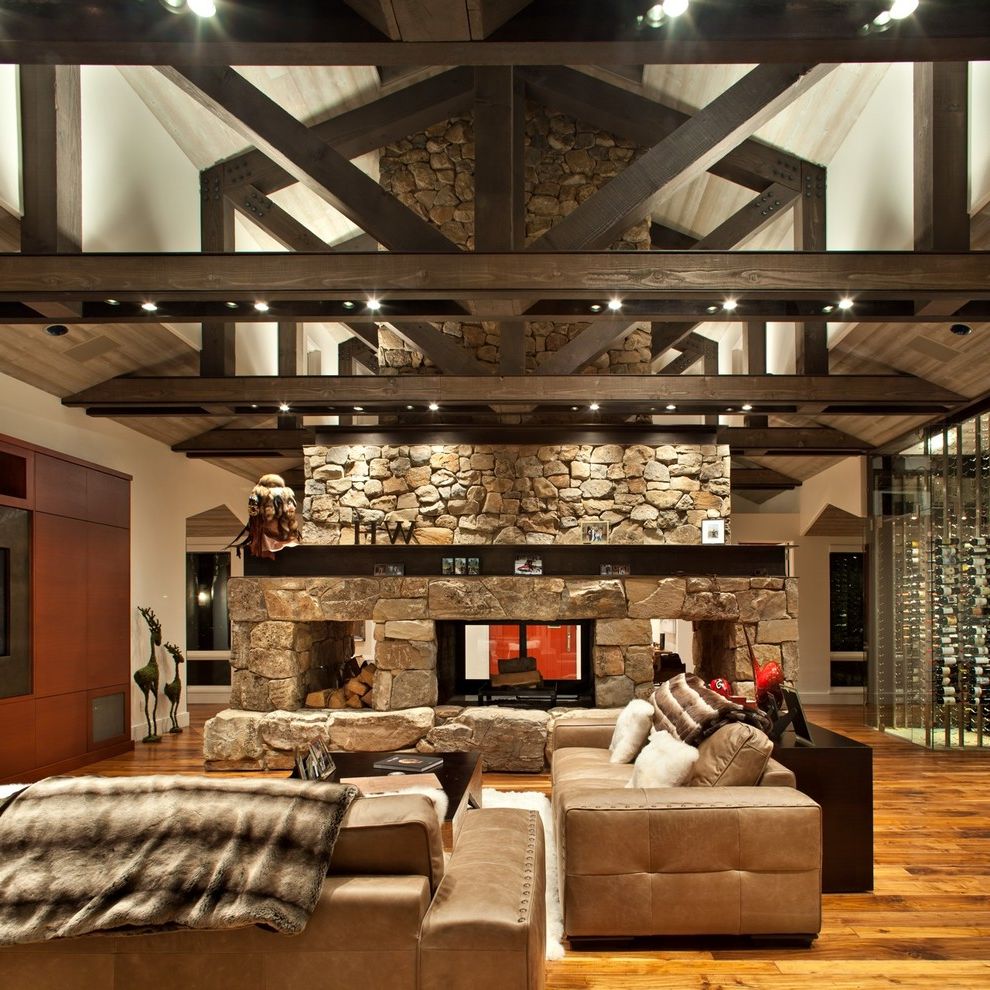 Sky Lodge Park City with Rustic Family Room Also Beige Sofa Contemprary Deer Statues Glass Wine Cellar High Ceiling Leather Sofa Medium Wood Floor Modern Park City Stone Fireplace Two Sofas Two Way Fireplace Wine Storage Wood Trusses