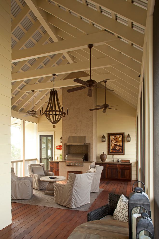 Smoke Eater Ceiling Fans with Beach Style Porch  and Ceiling Fan Chandelier Dark Wood Decking Outdoor Chairs Pitched Ceiling Slipcovered Chairs White Beams