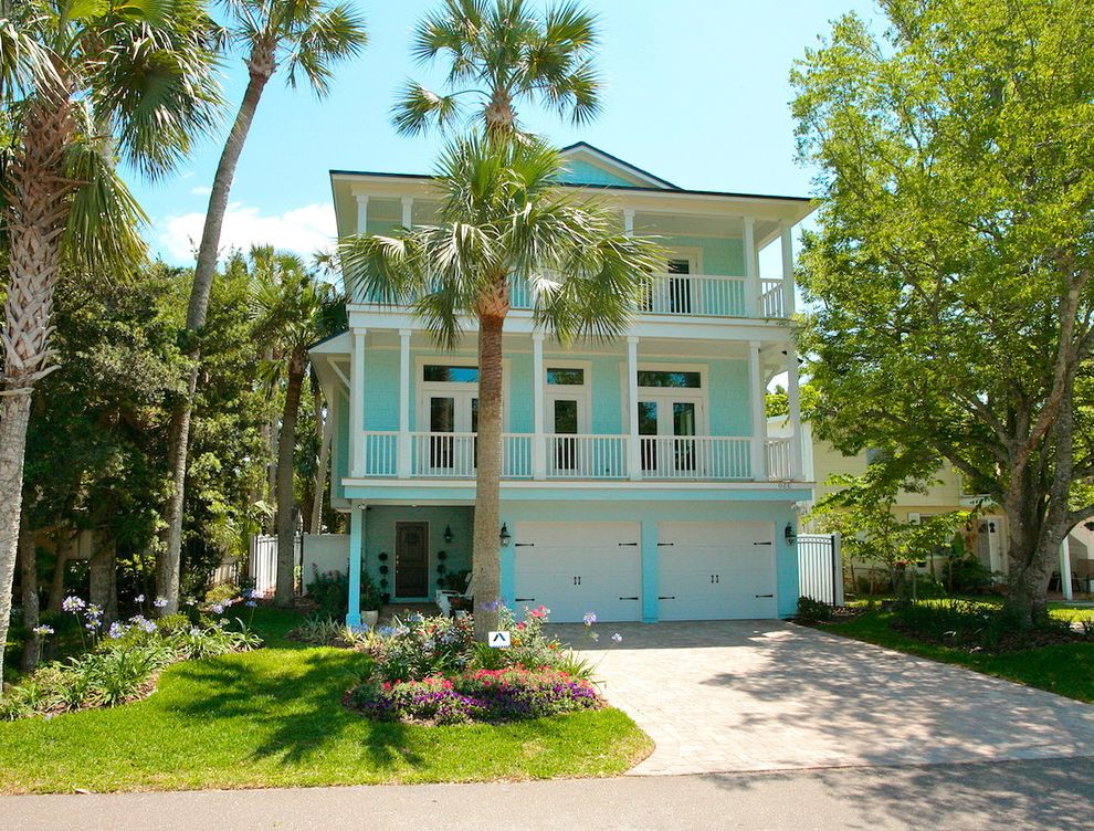 St Pete Housing with Tropical Exterior Also Balcony Beach House Carriage Doors Entrance Entry Garage Doors Grass Lawn Palm Trees Turf Turquoise