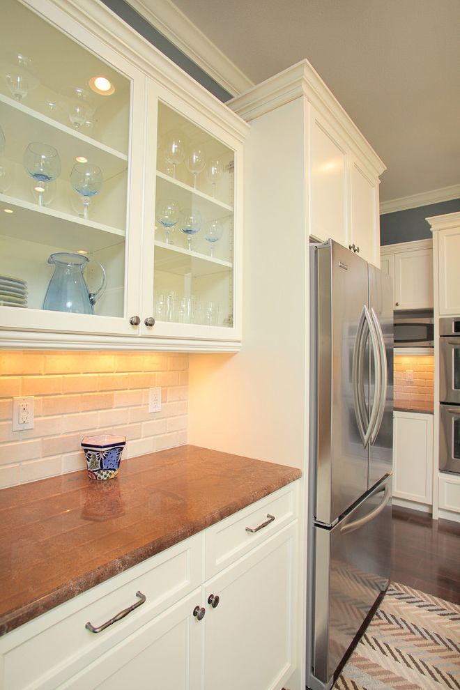Standard Fridge Depth   Traditional Kitchen Also Area Rug Brown Frame and Panel Cabinets Glass Panel Cabinets Granite Counters Gray Stainless Steel Appliances Subway Tile Tile Backsplash White Paired Trim Wood Floor