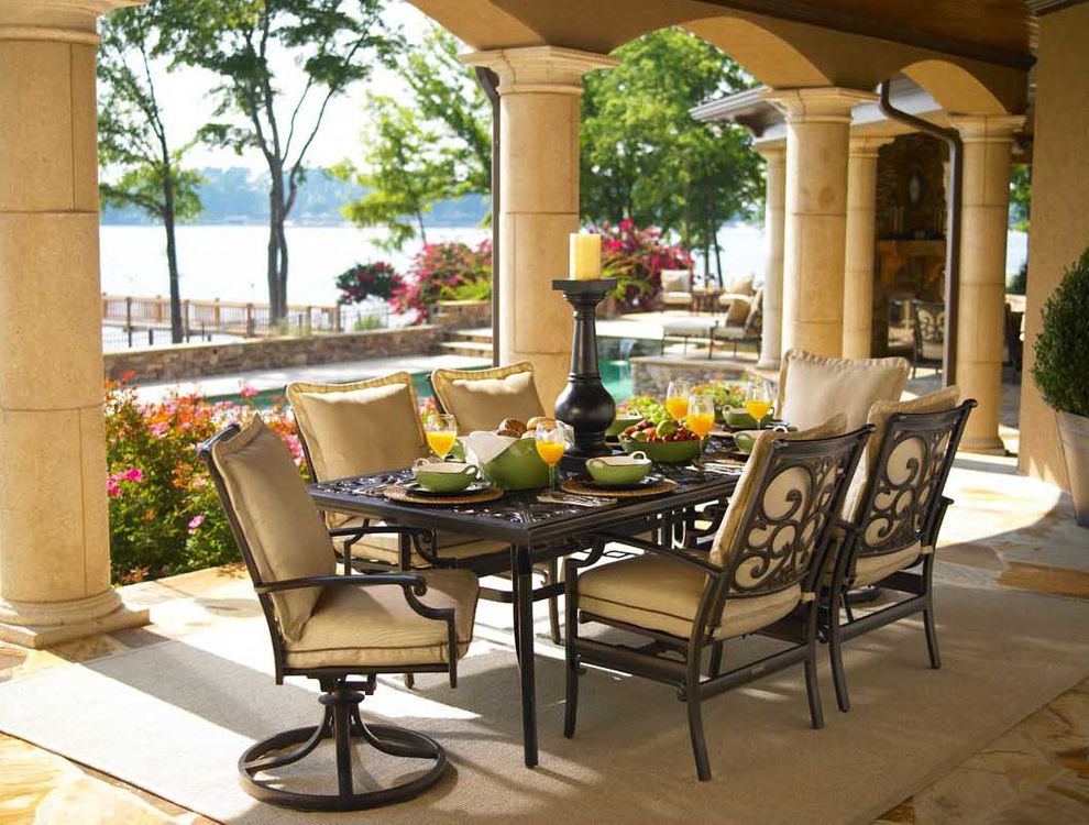 Tall Candle Pillars with Eclectic Patio  and Arch Area Rug Candle Holder Candles Columns Covered Walkway Entertaining Formal Frame View Iron Neutral Colors Outdoor Cushion Outdoor Dining Outdoor Furniture Outdoor Seating Patio Furniture Rug Stone View
