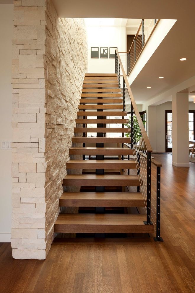 Thick Stair Treads with Modern Staircase  and Cable Rail Modern Stair Open Riser Skylights Stone Veneer Stone Wall