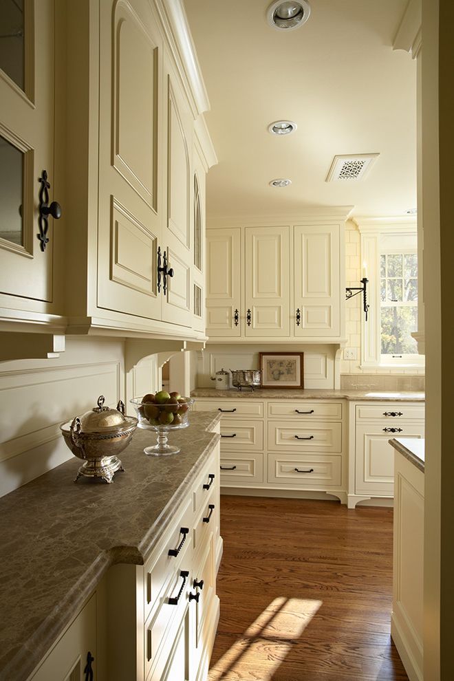 Tudor Definition   Traditional Kitchen  and Butlers Pantry Corbels Emperador Light Marble Hardware Inset Cabinetry Marble Countertops Painted Cabinetry Paneled Backsplash Sconces Tudor Style Kitchen Wall Sconces White Cabinets White Kitchen