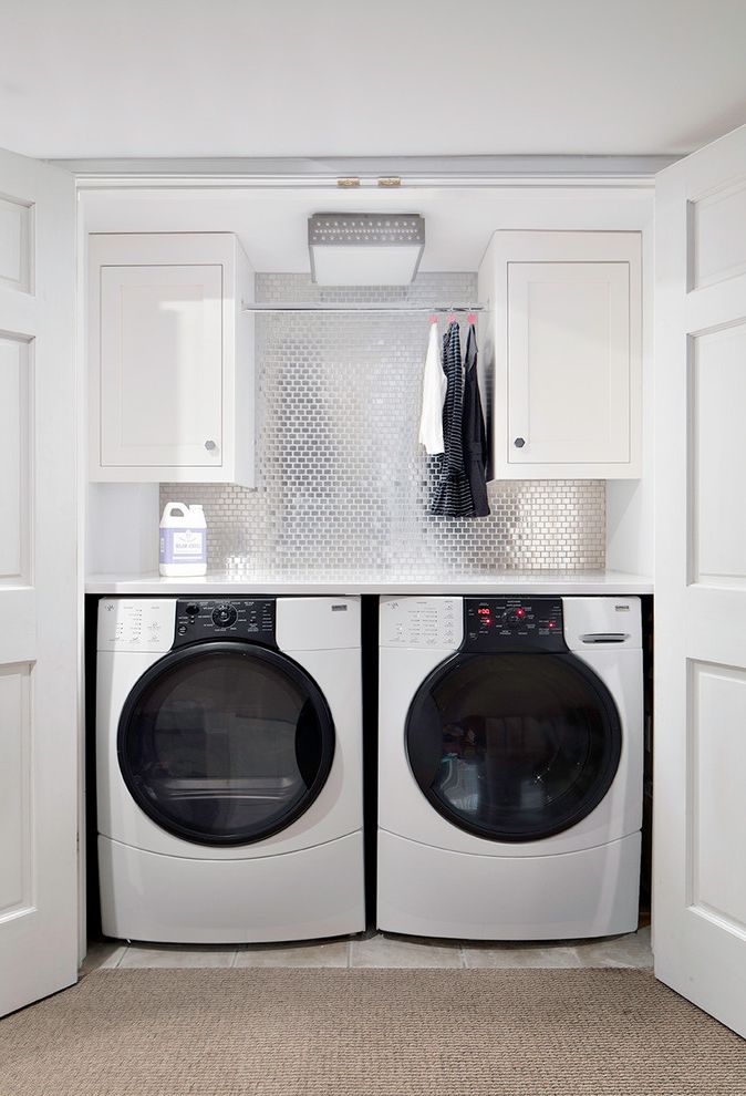 What is He Detergent with Transitional Laundry Room  and Alcove Carpet Ceiling Light Front Loading Washer and Dryer Hanging Rod Laundry Closet Laundry Storage Metallic Backsplash Nook White Cabinets White Doors