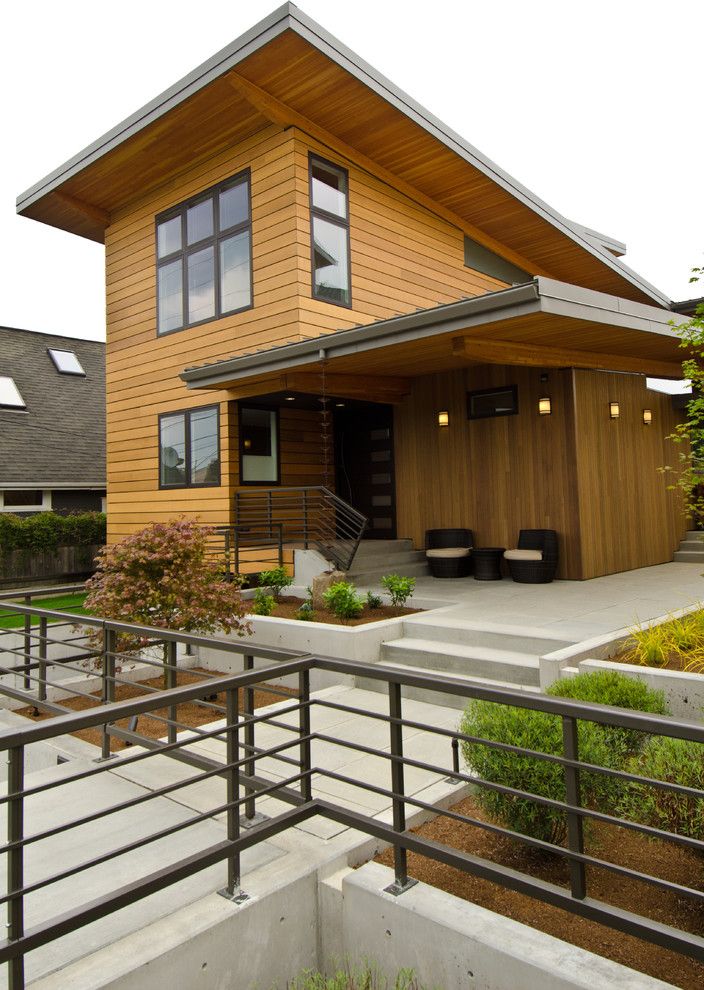Cedar Siding Cost with Contemporary Exterior Also Concrete Hardscaping Large Window Metal Railing Metal Roof Modern Overhang Patio Paver Pathway Rain Screen Retaining Wall Sloped Roof Standing Seam Roof Steel Railing Wood Wood Siding