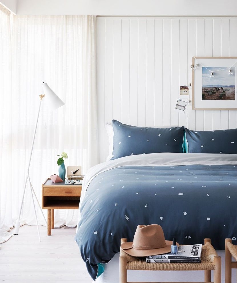 Navy Blue Bed Sheets with Contemporary Bedroom  and Art Print Bedding Bedroom Contemporary Bedroom Floor Lamp Modern Floor Lamp Navy Blue Navy Blue Bedroom Neutral Panelling Timber Side Tables Wall Panelling White Floor Lamp White Walls