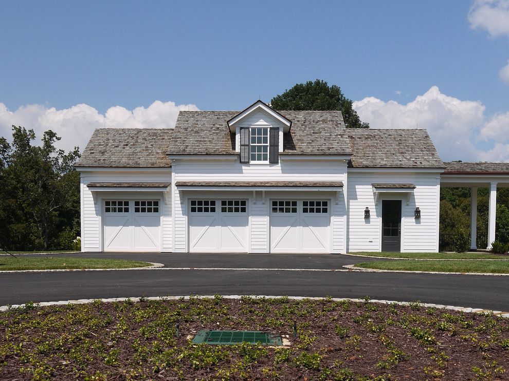 Brad Smith Roofing with Traditional Garage  and Black Window Shutters Carriage House Detached Garage Three Car Garage Wall Sconce White Exterior White Garage White Garage Door White Siding