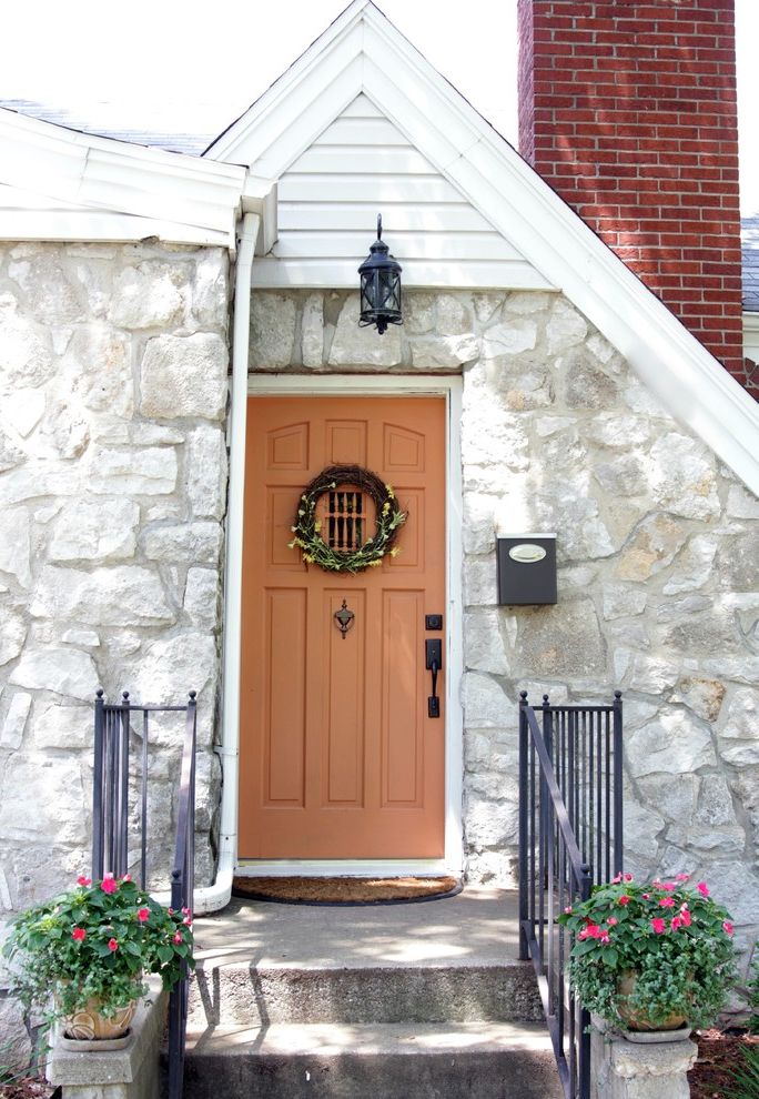 How to Fix a Hole in a Door   Traditional Entry Also Brick Chimney Concrete Steps Cottage Gable Roof Iron Railng Plant Pots Stone Facade White Painted Wood Wood Door Wreath