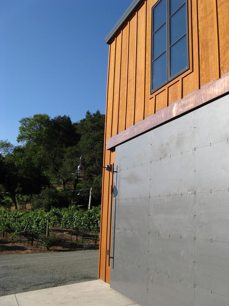 Metal Garage with Apartment   Industrial Shed Also Barn Hinge Board and Batten Driveway Grapes Gravel Landscaping Riveted Metal Vineyard