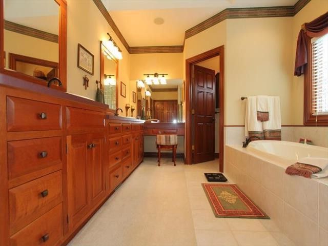 Sibcy Cline Cincinnati Ohio   Traditional Bathroom  and Ceramic Flooring Carpeting Cherry Cabinetry Double Sinks Master Bathroom Owners Suite Private Retreat Soaker Tub Vanity Area